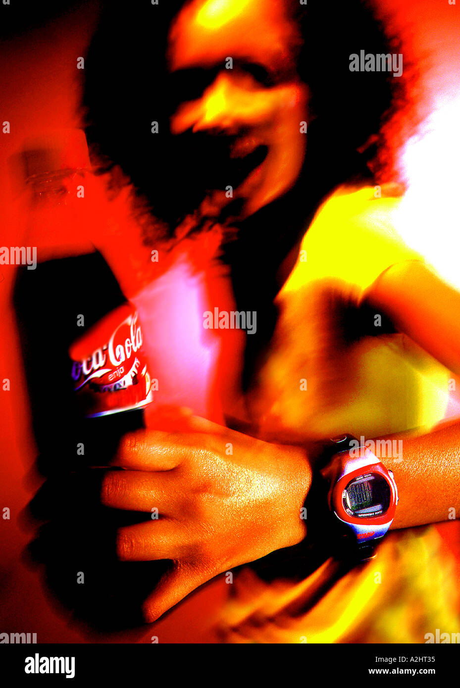 Mixed race girl age 20-25 at a party drinking coke. Stock Photo