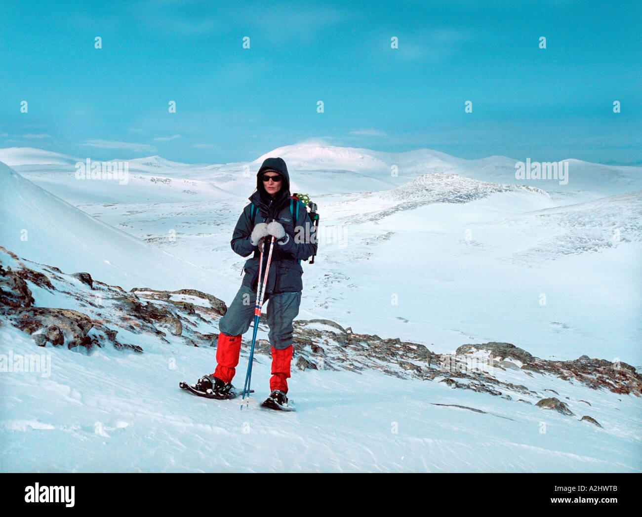 A woman standing with snow shoos on snowy landscape Helags mountain Härjedalen Sweden Europe Stock Photo