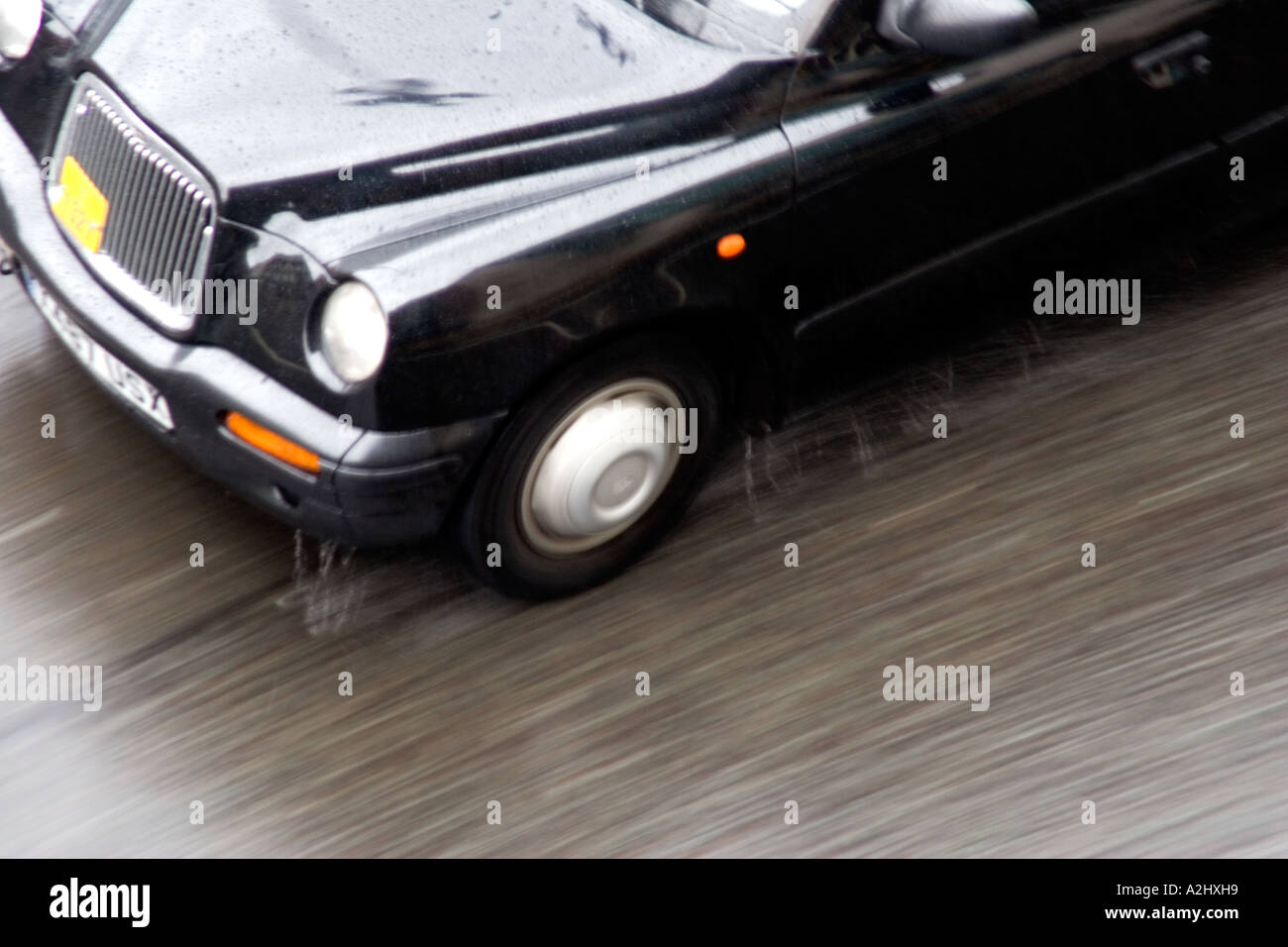 Black cab in the rain Stock Photo