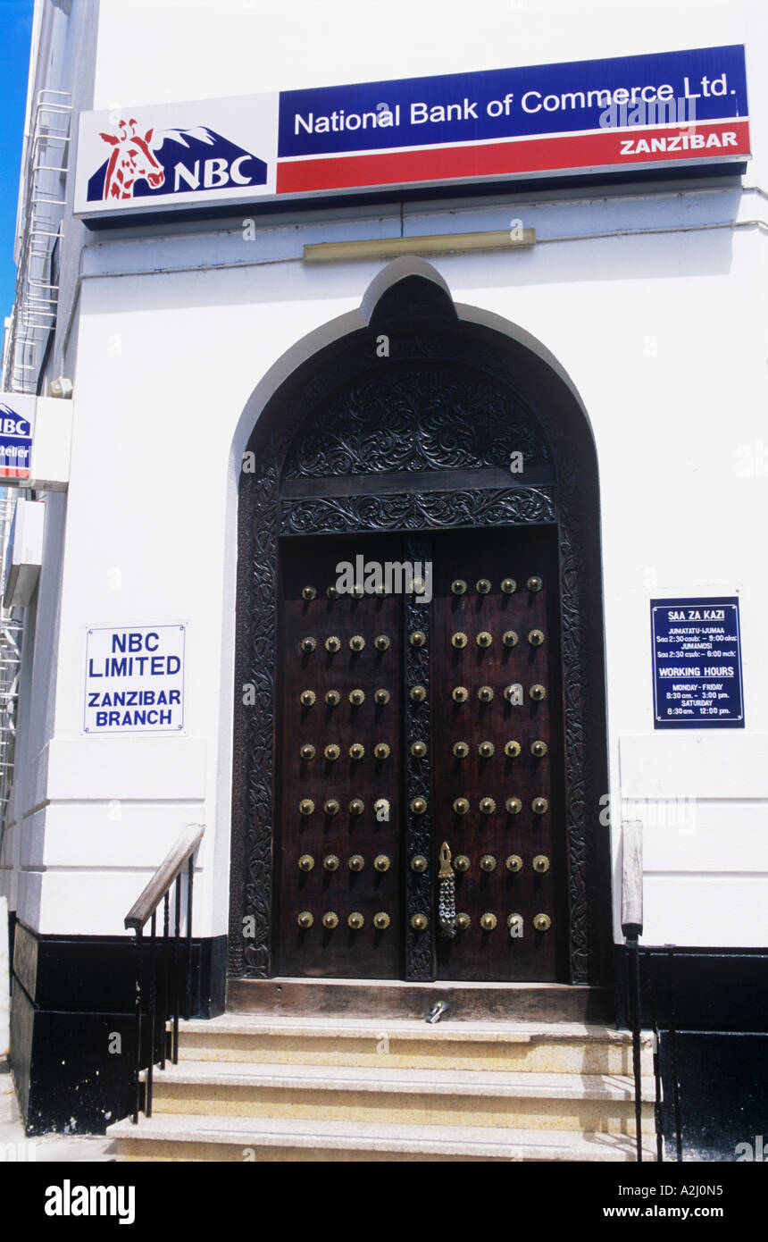 Well-preserved teak doors guard the National Bank of Commerce, jointly owned by Zanzibar and South Africa Stock Photo