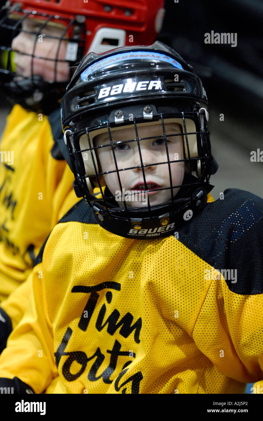 5 year old boys learn how to play the game of ice hockey Stock Photo