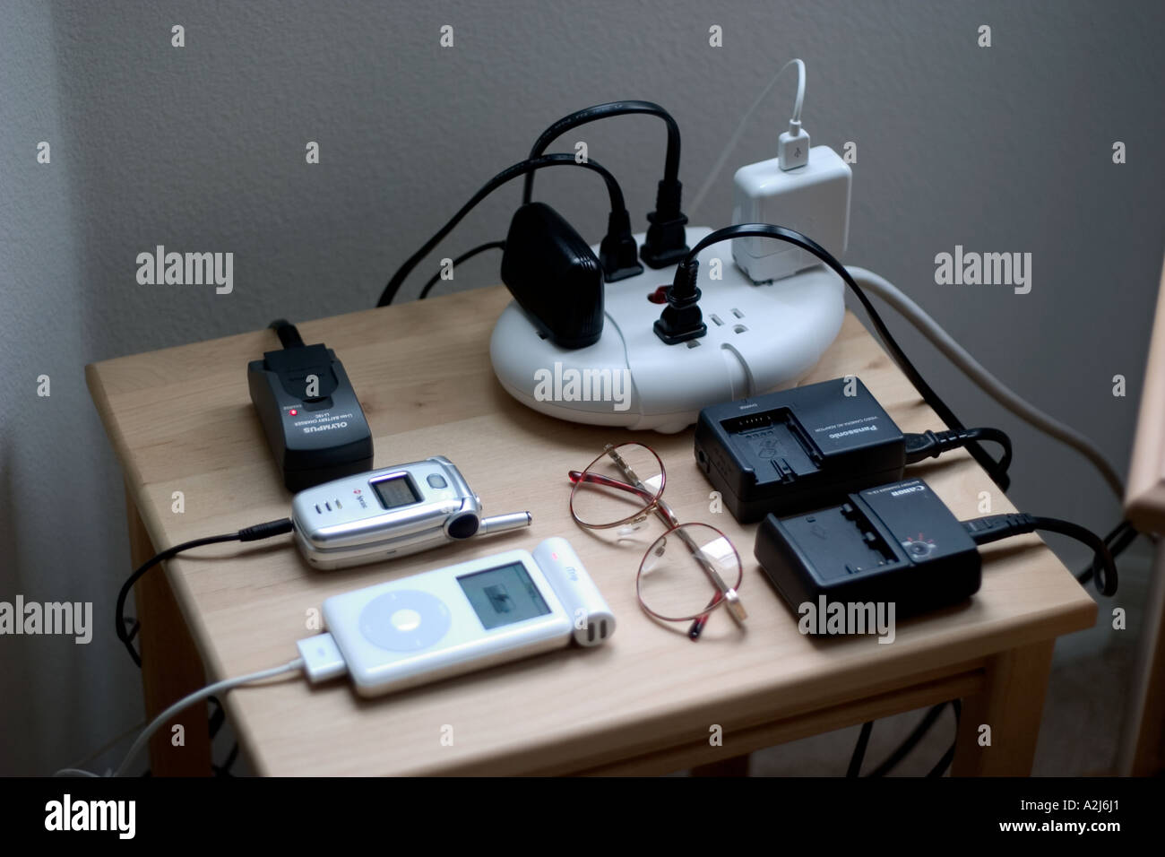 Electrical cords lead to multiple outlet extension cord to charge batteries for cameras cell