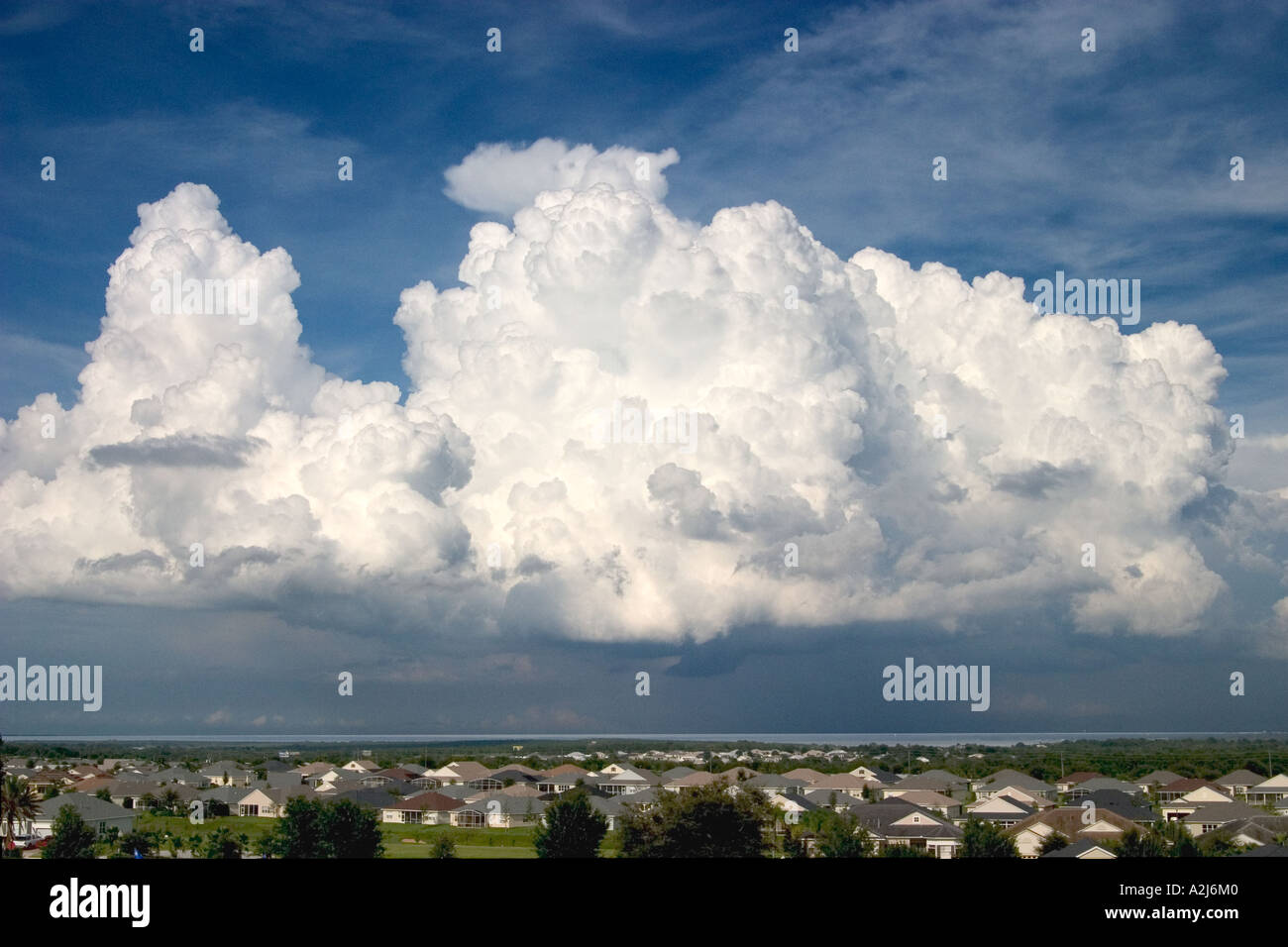 Storm clouds form over Florida. The landscape shows houses and Lake Apopka in the distance Stock