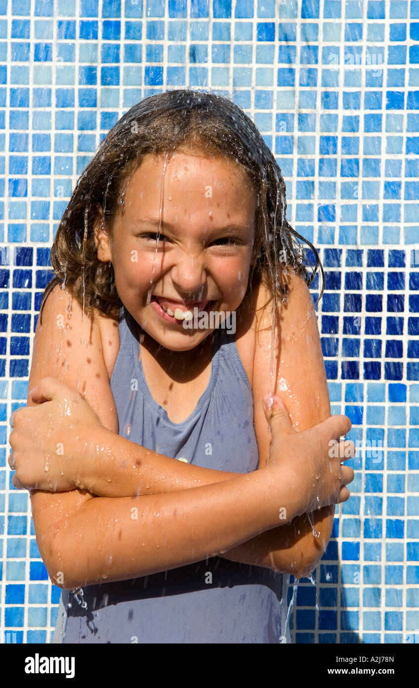 teenage girl freezes under cold shower outside Stock Photo Alamy