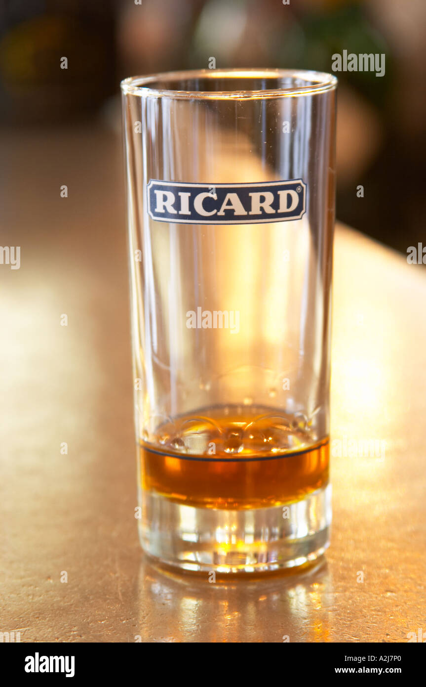 A glass of Ricard 45 pastis on a zinc bar in a cafe in Paris. Part of a  series of photos showing that when you add ice and water the drink becomes