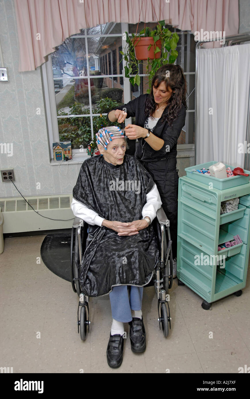 Senior elderly Woman has hair cut shampoo color and permanent done by a
