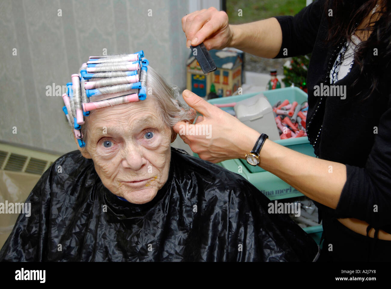 Senior elderly Woman has hair cut shampoo color and permanent done by