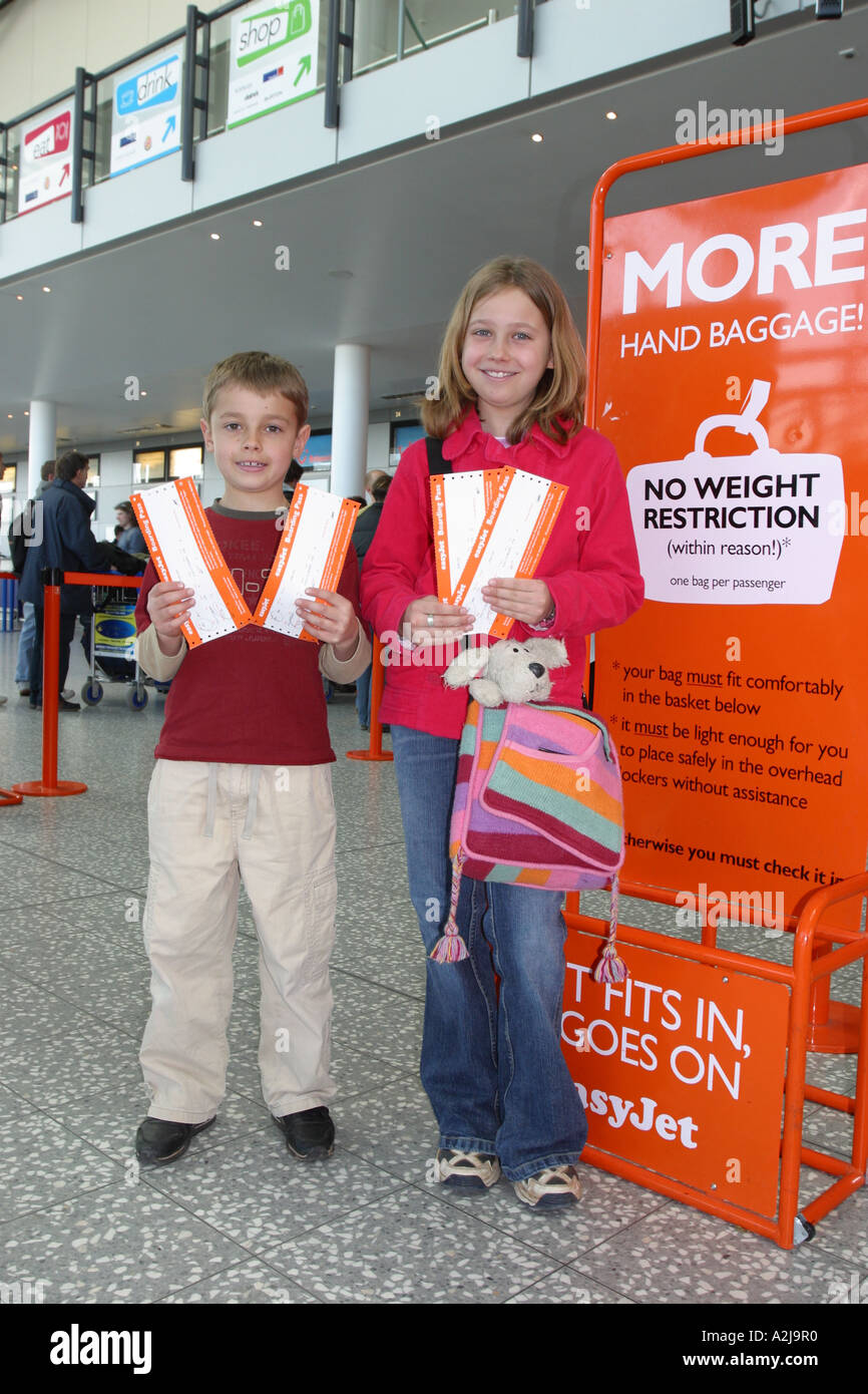 Young boy and girl children airline passengers proudly showing their