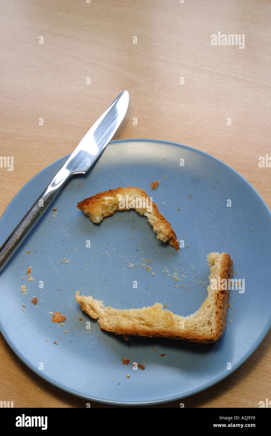 Toast crust leftovers on plate Stock Photo