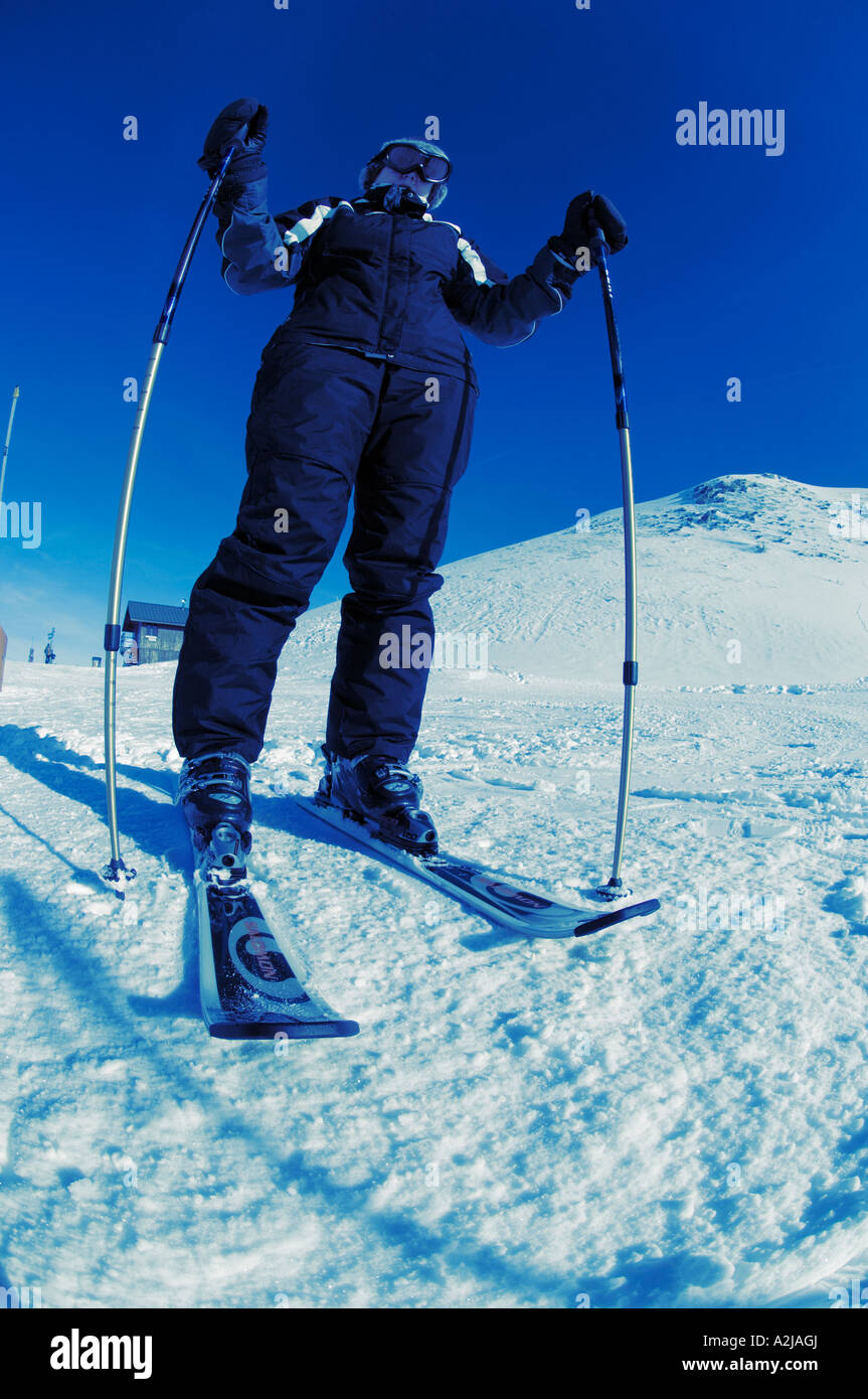 Woman skier photographed from ground level Stock Photo