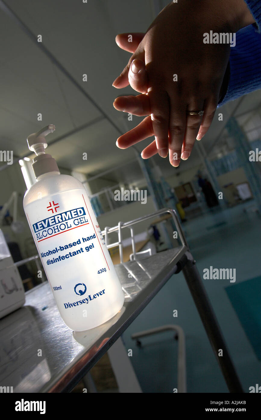 A nurse washes her hands in alcohol gel on a hospital ward as a precaution aginst the hospital superbug MRSA. Stock Photo