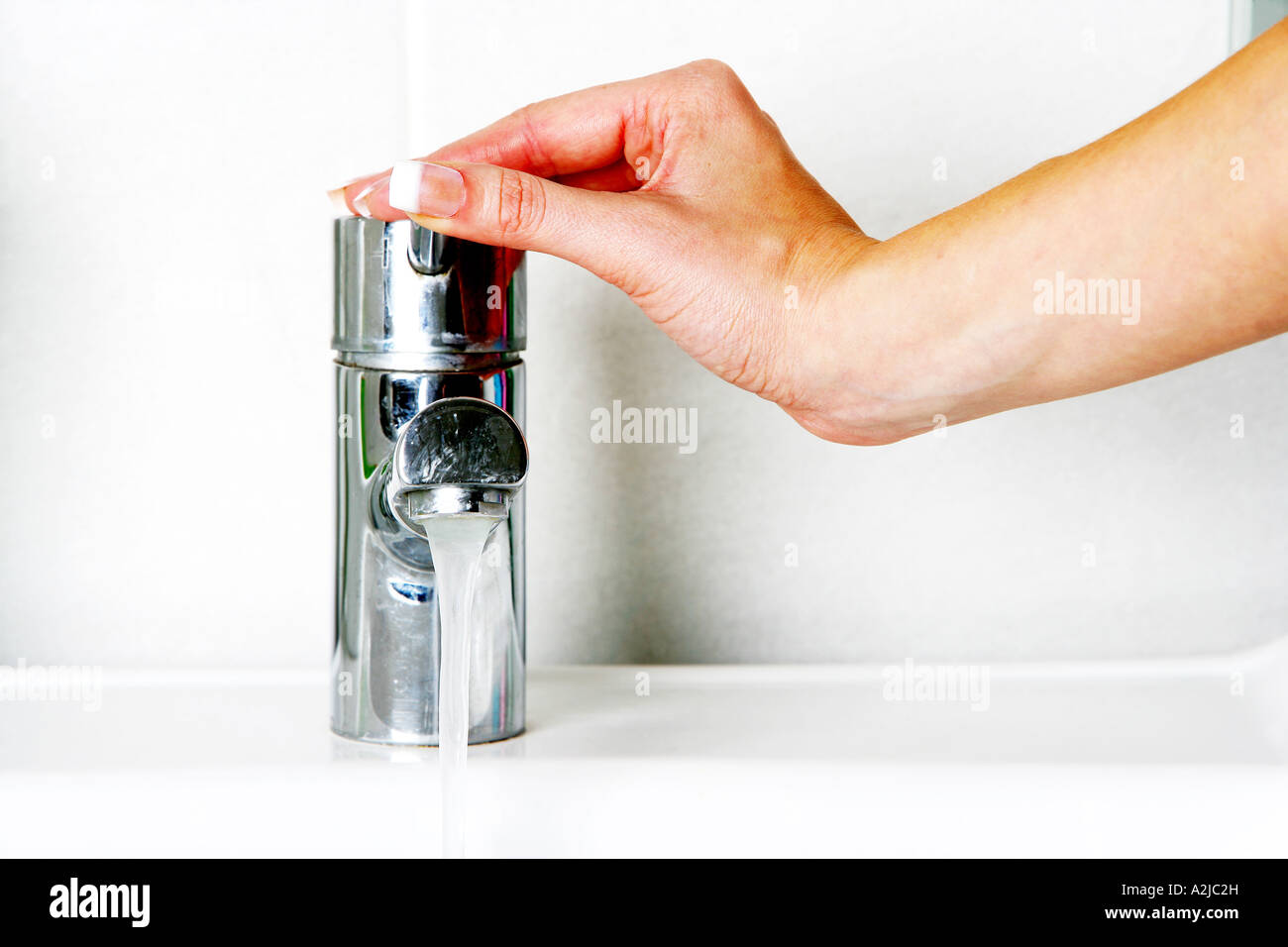 Young Woman Washing Her Hands In A Bathroom Sink With Soap And Water ...
