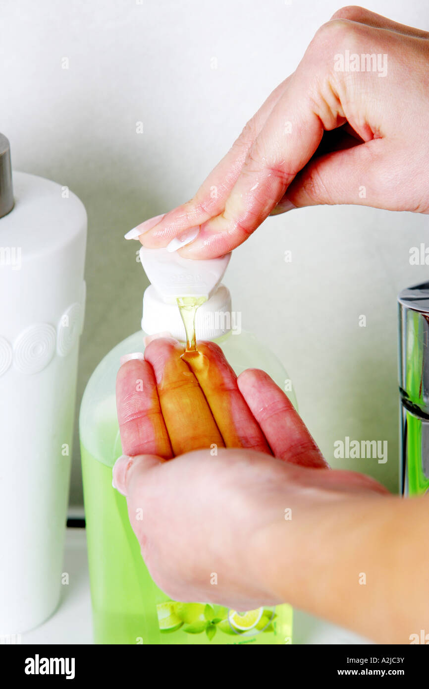 Young Woman Washing Her Hands In A Bathroom Sink With Soap And Water ...