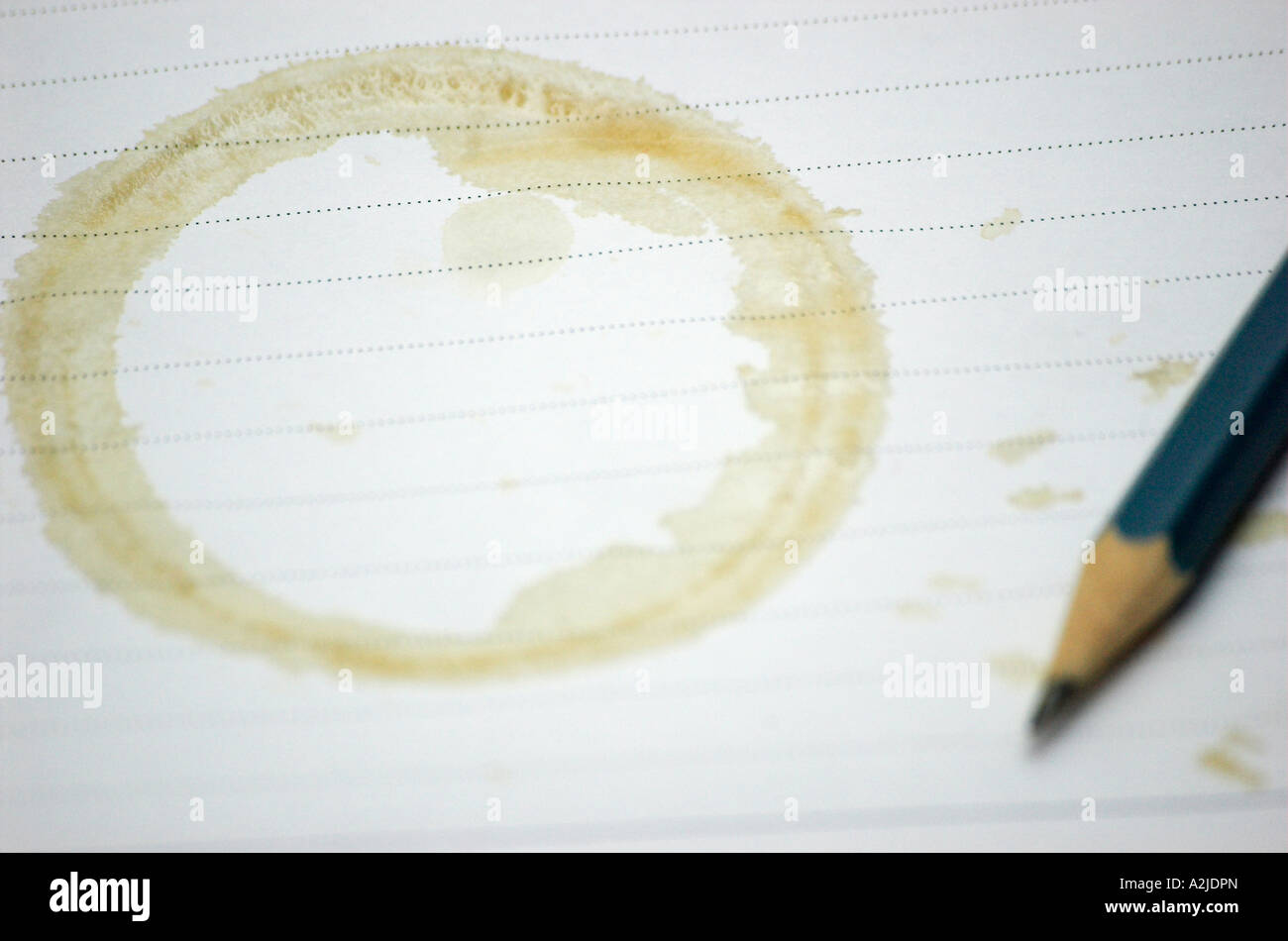 Coffee stain on note book with pencil Stock Photo Alamy
