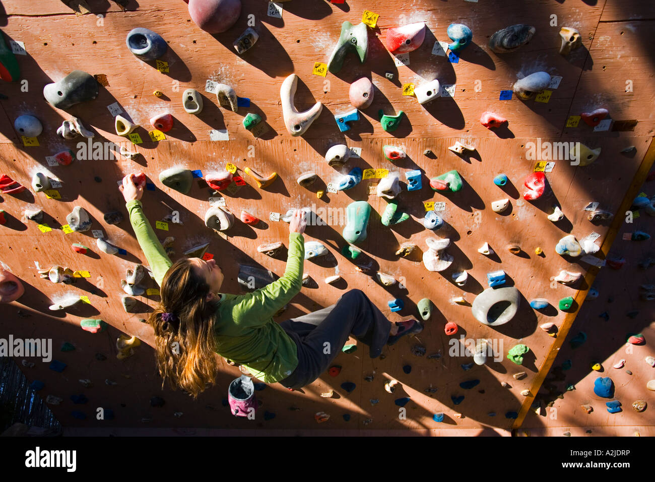 Steph Davis climbing on her outdoor climbing wall Moab Utah Stock Photo