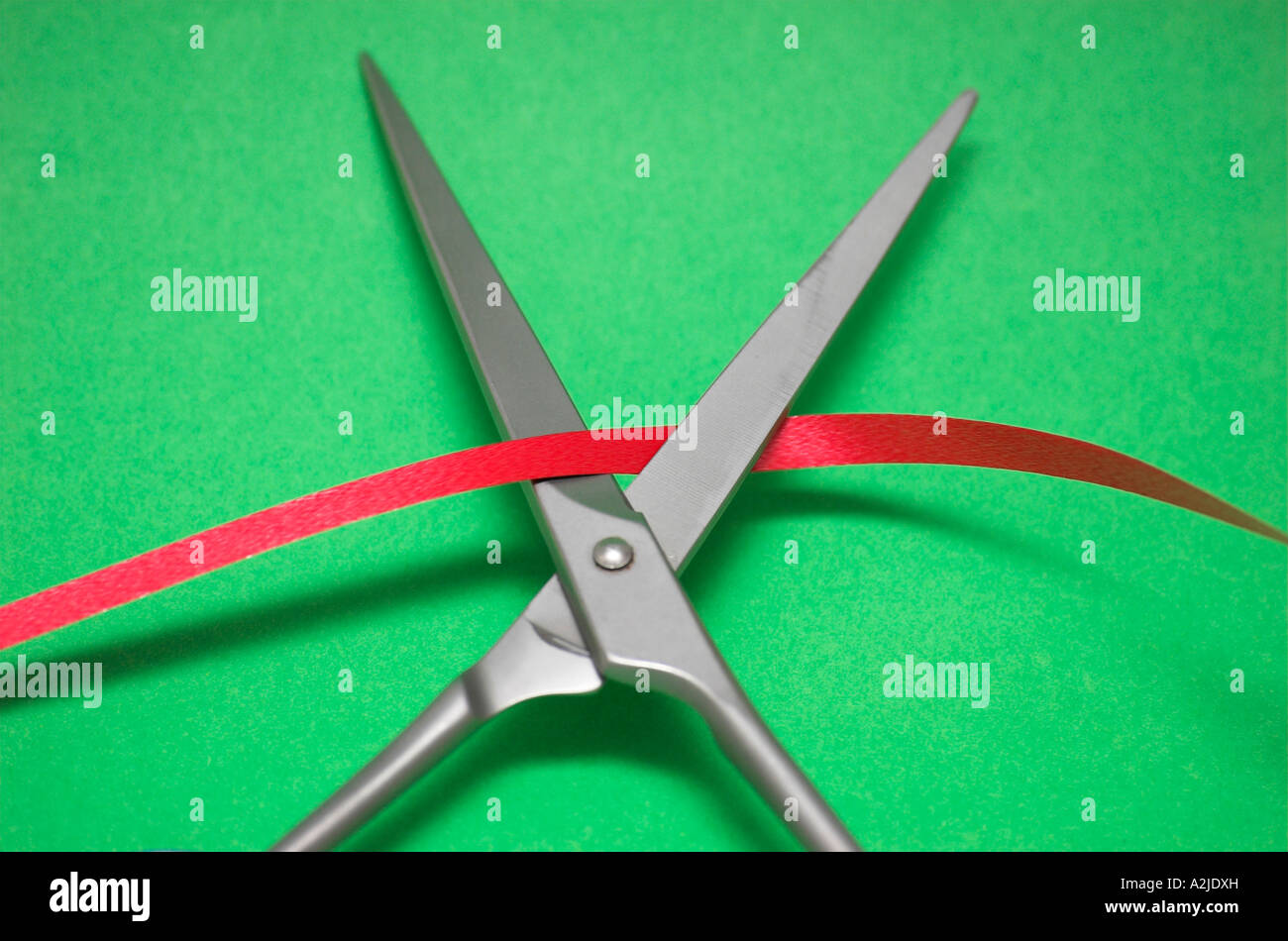 Scissors cutting red tape Stock Photo Alamy