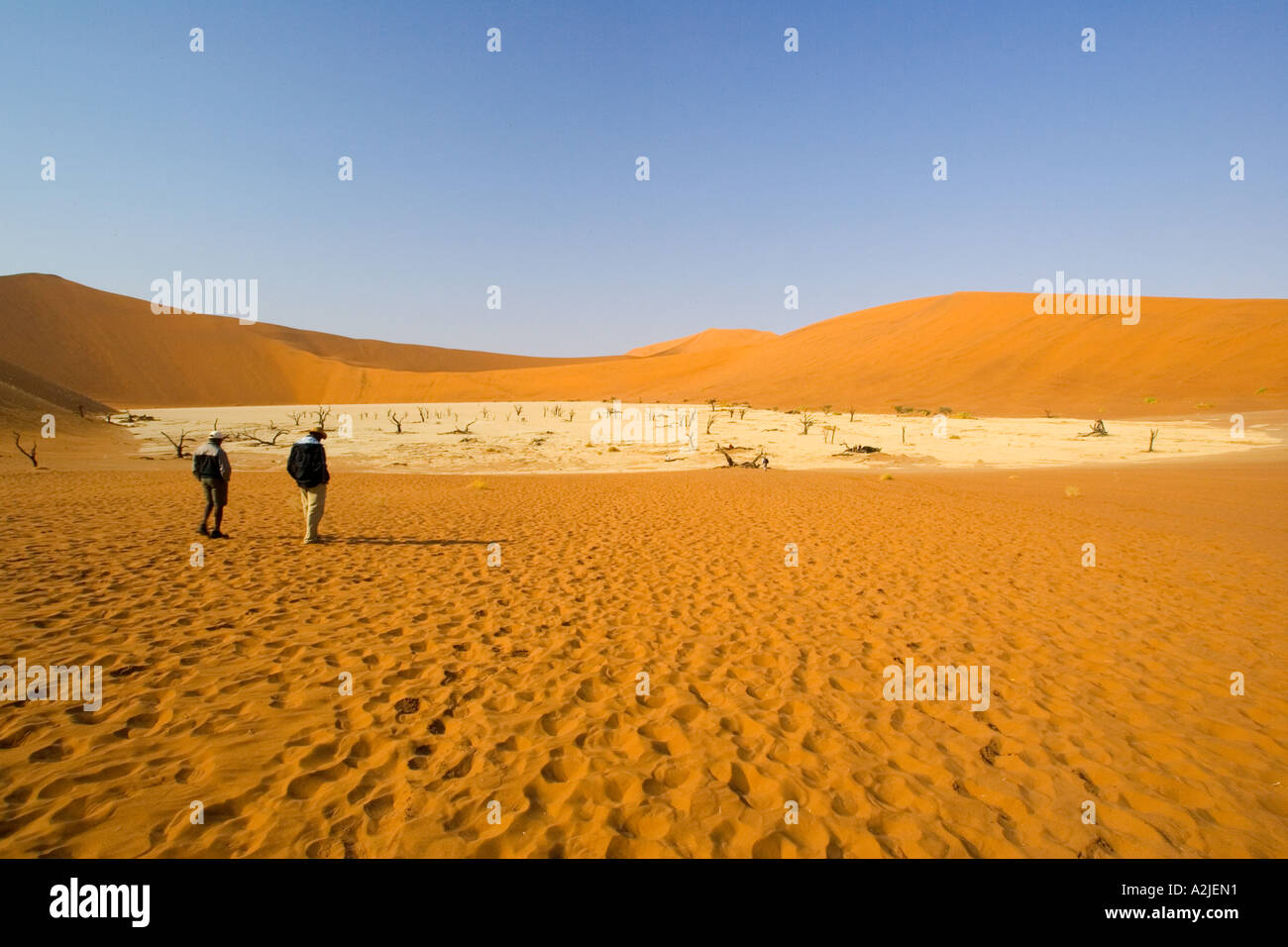 Namibia, Africa: Two Hikers at Sossusvlei (Deadpan) Stock Photo