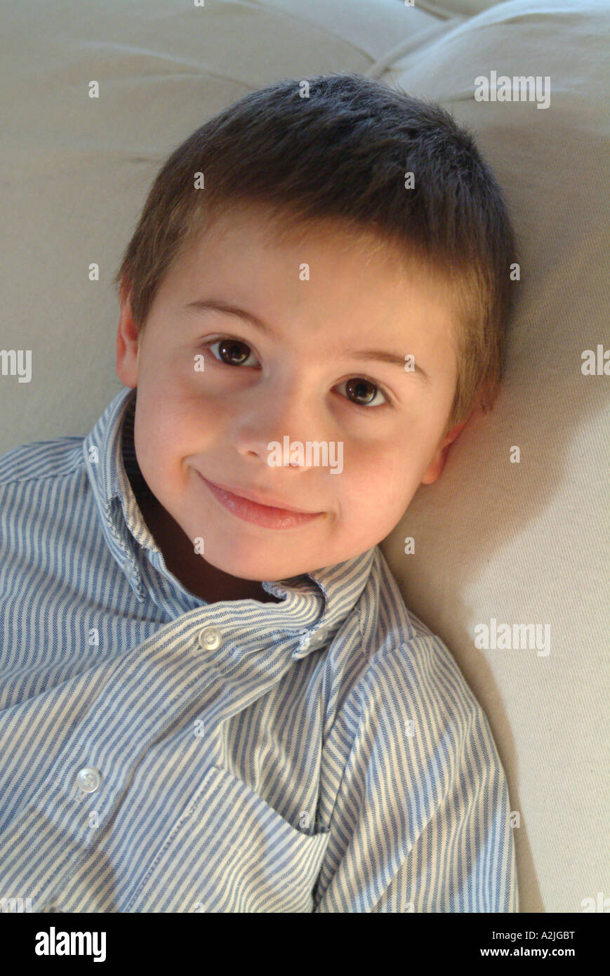 A five year old white boy handsome portrait on sofa Stock Photo Alamy