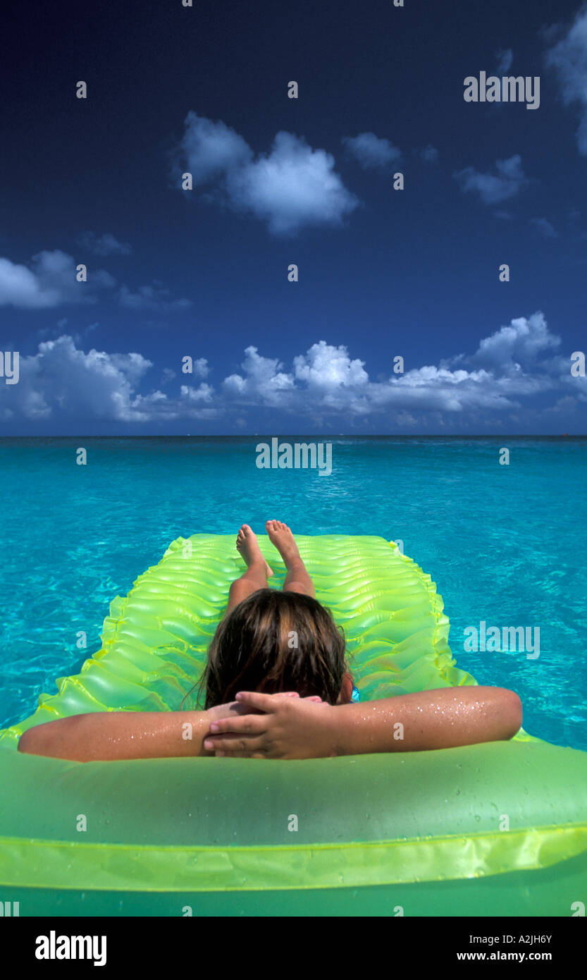Grace Bay Provodinciales Caribbean Tropics girl floats on green raft in ...