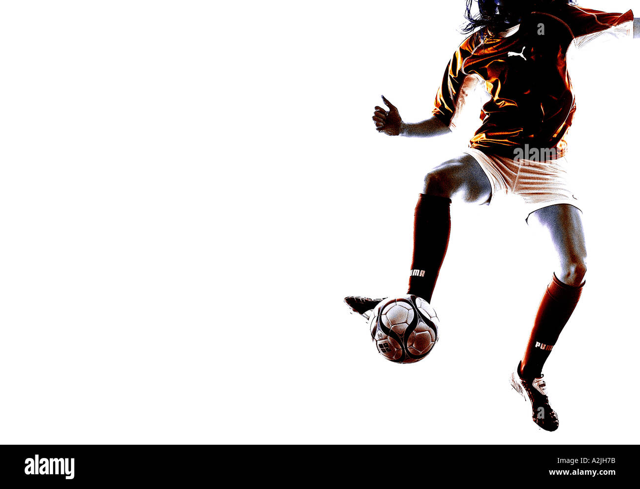 woman playing football in a studio against a white background. Stock Photo