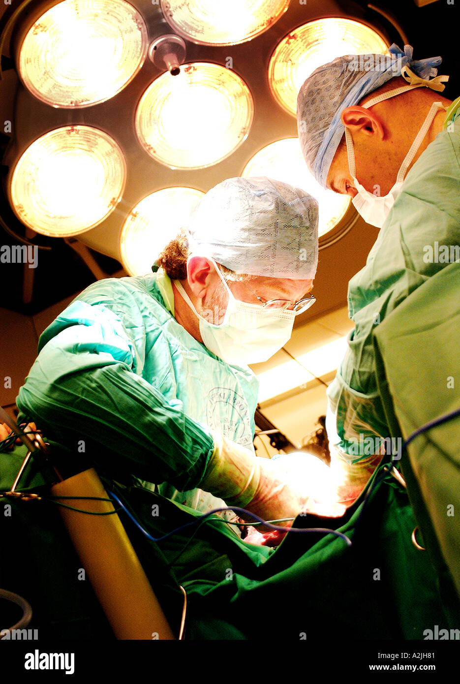 Doctors operating on a patient in a theatre in england. Stock Photo