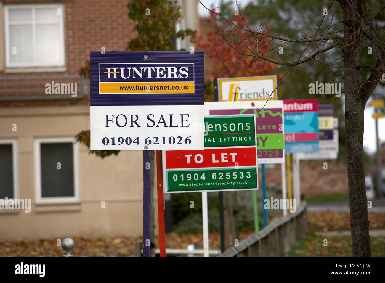 Several for sale and to let signs outside homes in York North Yorkshire