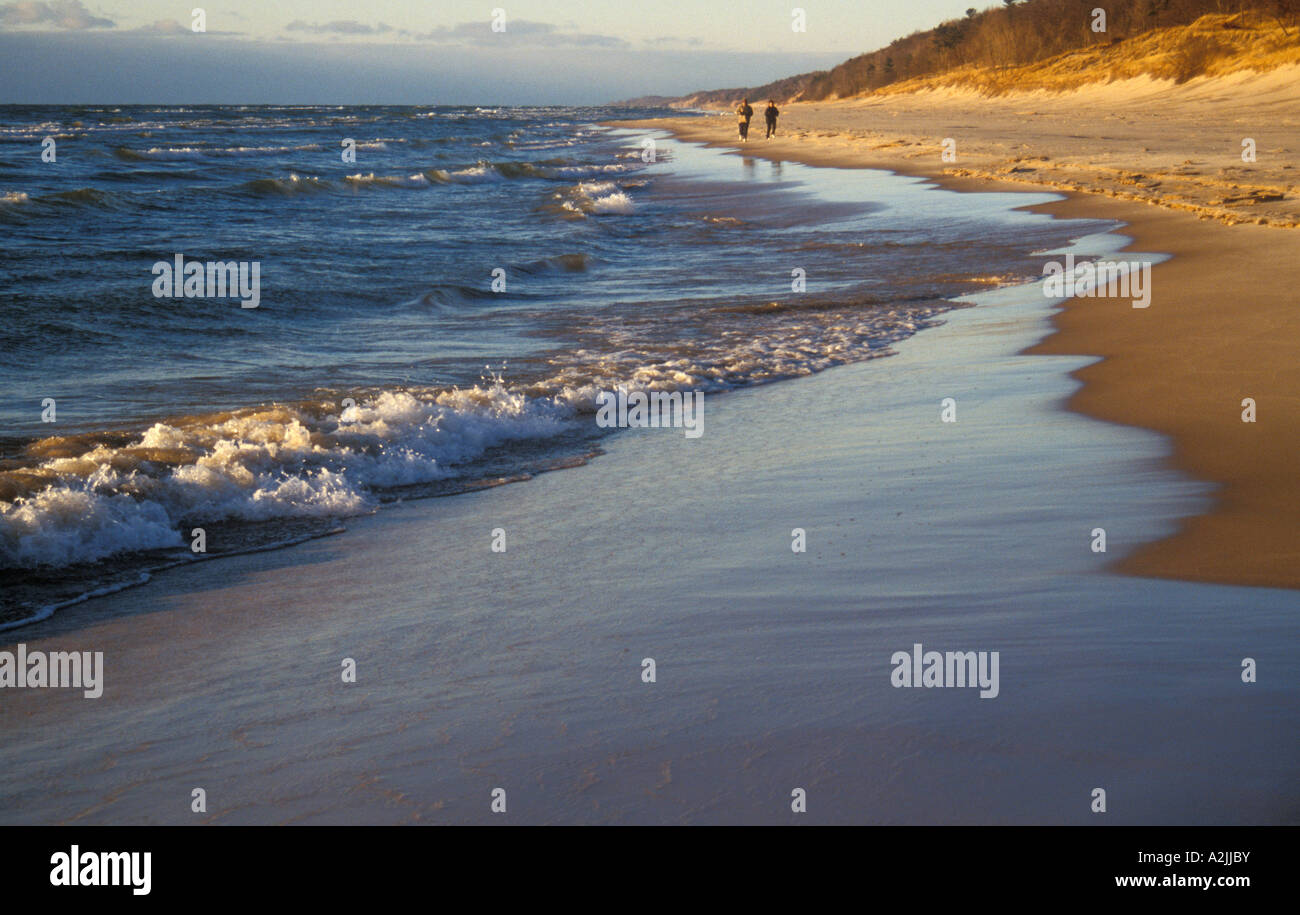Ferrysburg Michigan A couple walks on the beach along Lake Michigan in