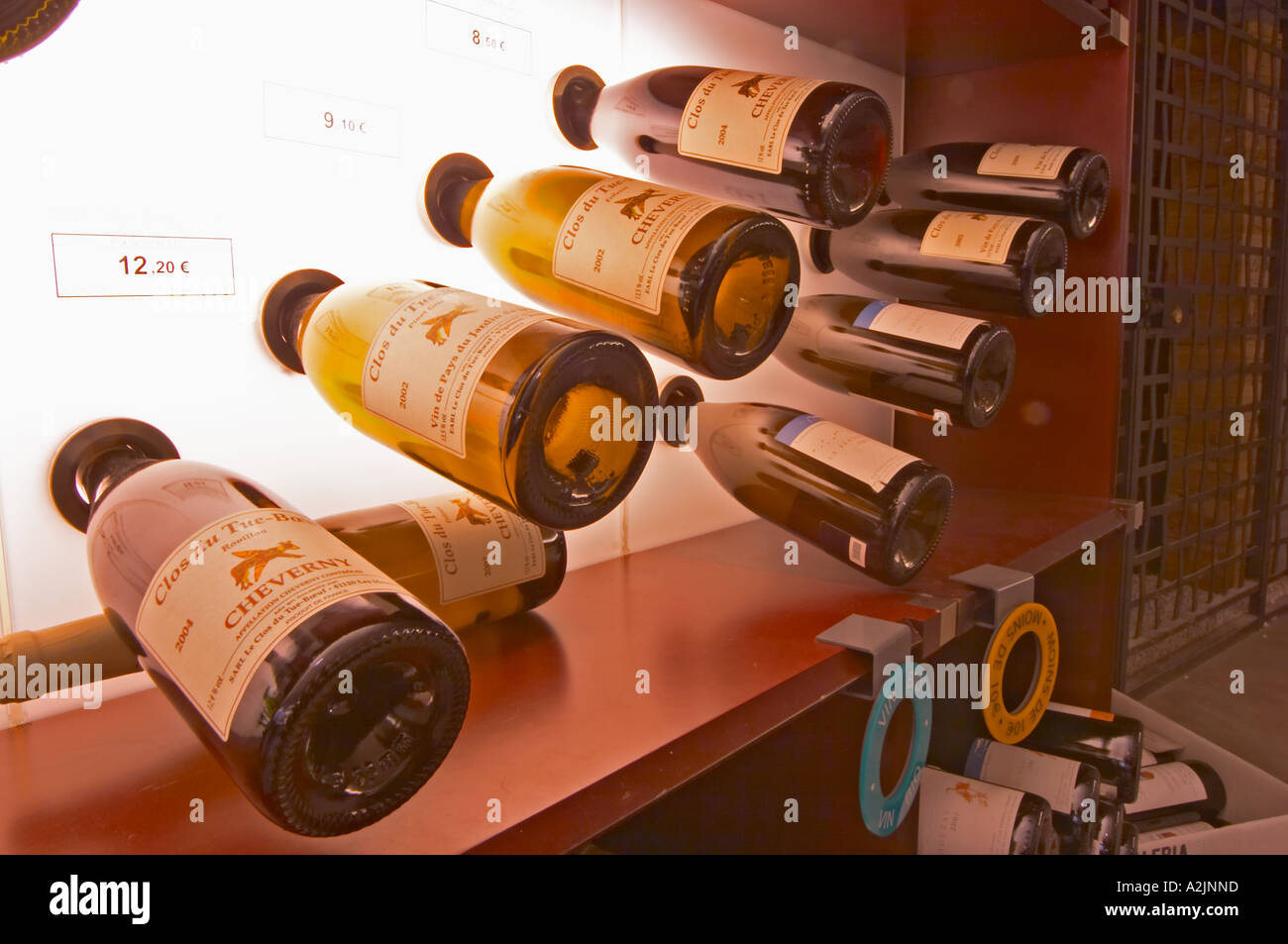 A curved display of bottles. Backlit The Lavinia wine shop in Paris