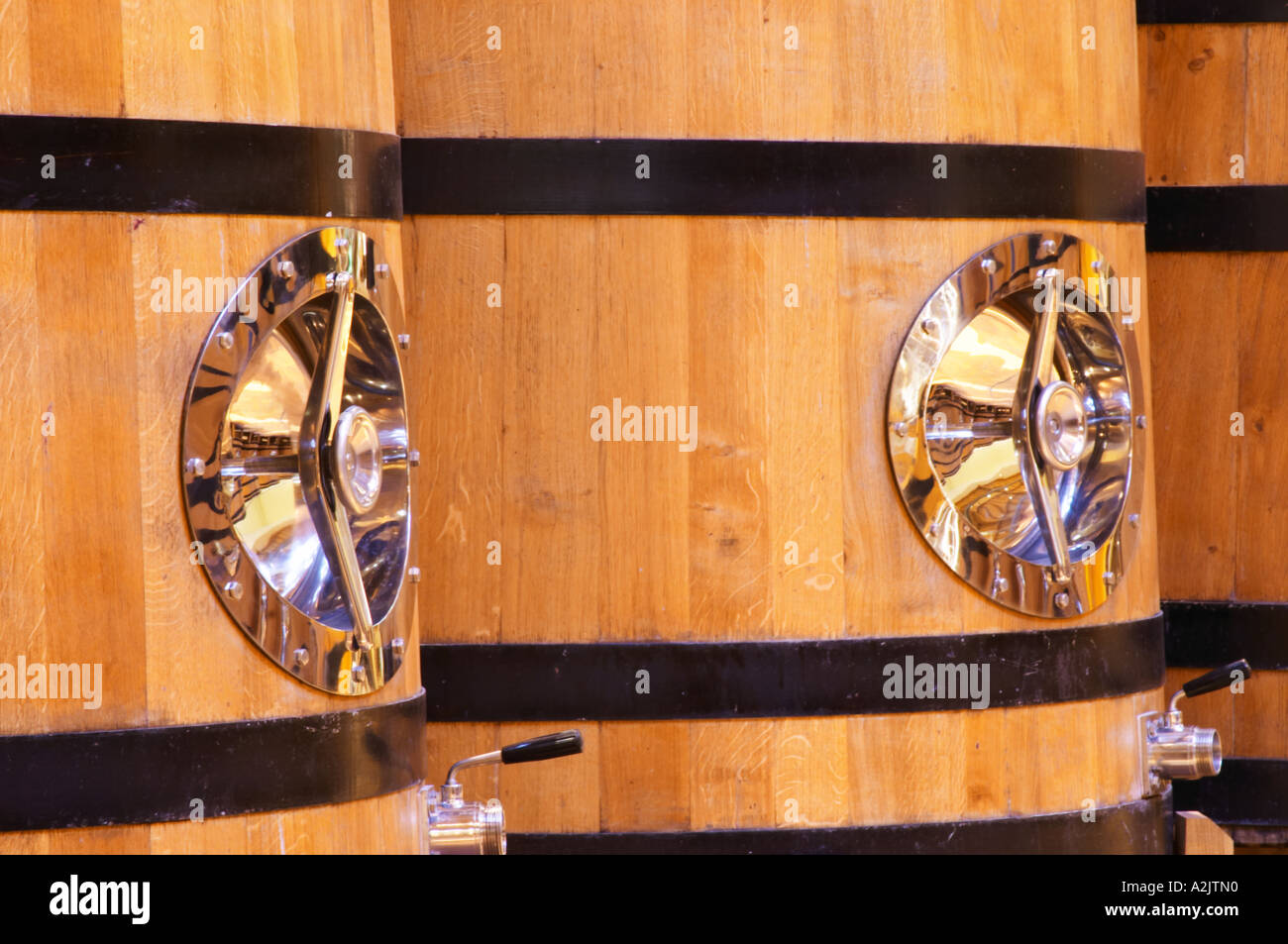 Detail of wooden fermentation tanks vats with a polished stainless steel door, Maison Louis Jadot, Beaune Côte Cote d Or Bourgogne Burgundy Burgundian France French Europe European Stock Photo