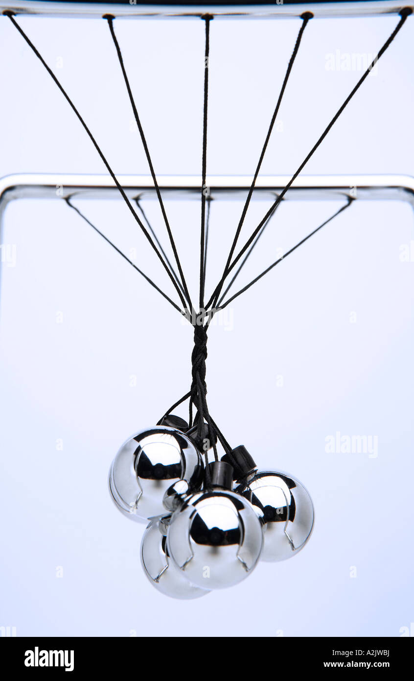 newtons cradle with balls tangled up, close up, portrait format Stock Photo  - Alamy