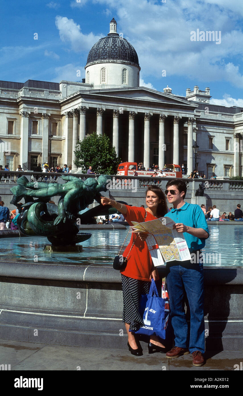 United Kingdom London Trafalgar Square Couple Reading Map Stock Photo
