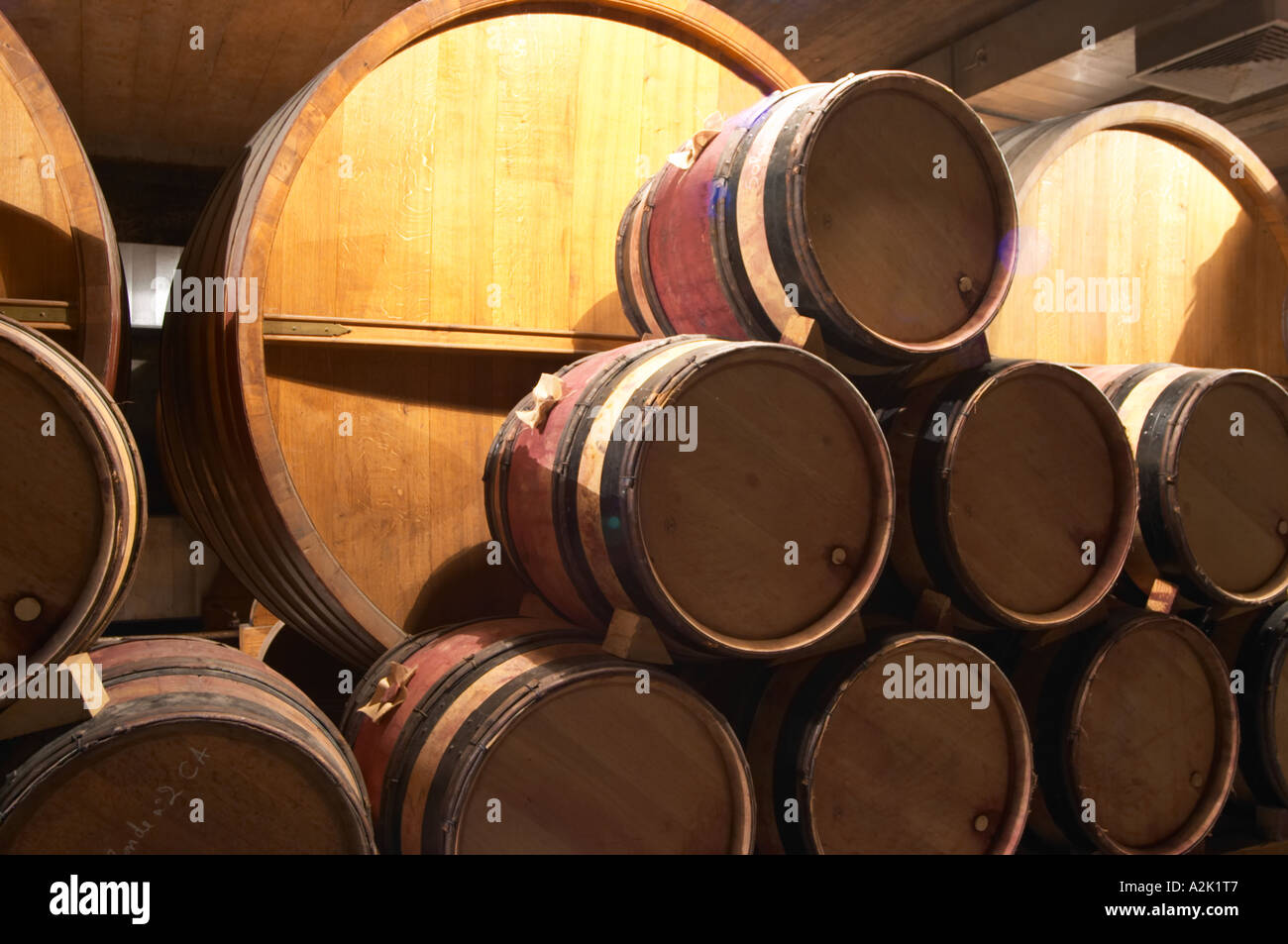 Wooden barrels with aging wine in the cellar of Guigal in Ampuis. The