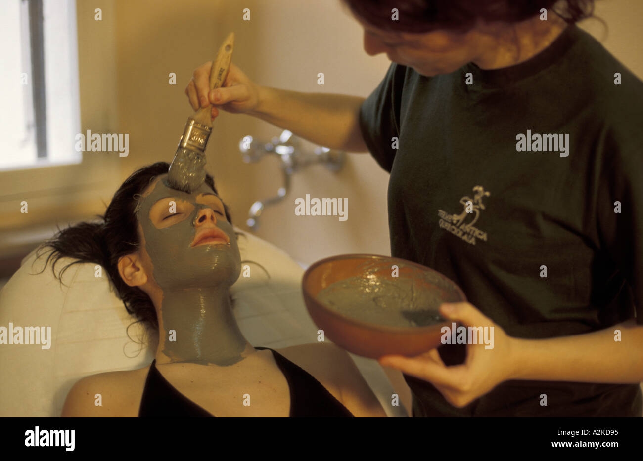 Woman takes a mud bath treatment Stock Photo - Alamy