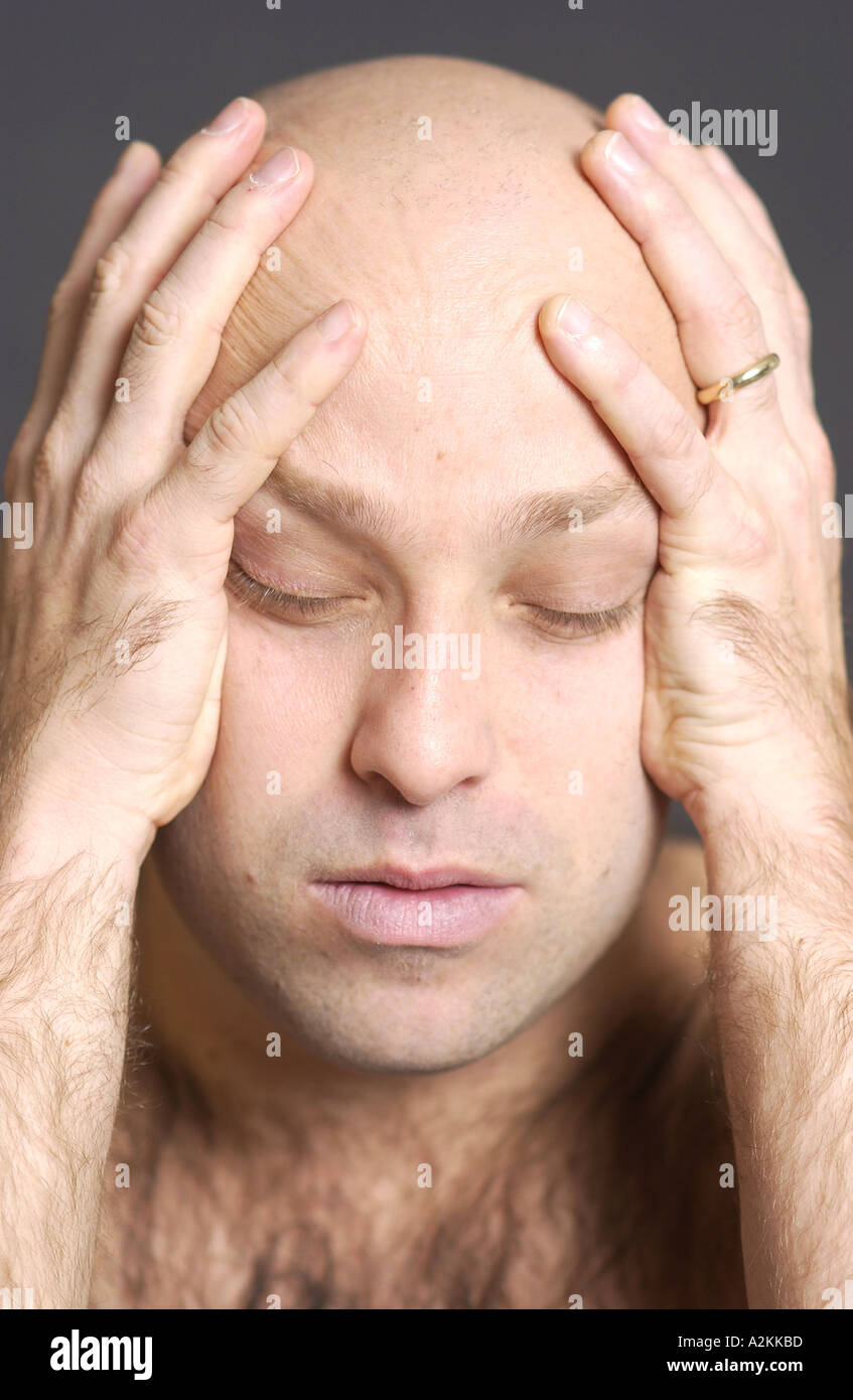 Bald Man Holding His Head In Contemplation Stock Photo Alamy