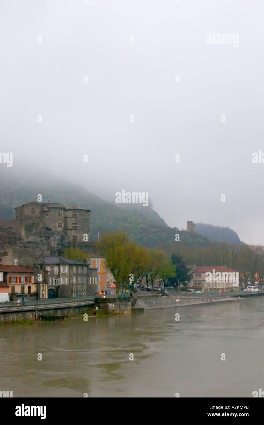 The town Tournon across the Rhone river with the Chateau de Tournon.  under snow in seasonably exceptional weather in April 2005. In the distance, the ruin of a tower.  Tain l’Hermitage, Drome, Drôme, France, Europe Stock Photo