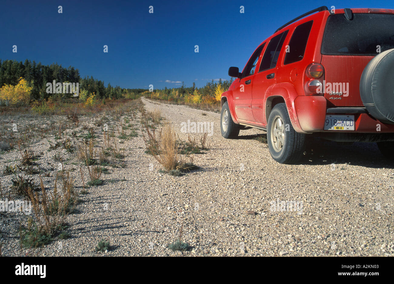 red car driving on a dirt road Stock Photo