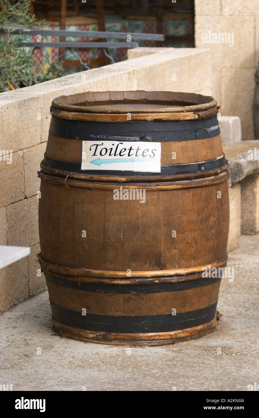 A wine barrel with a sign indicating the toilettes toilets rest 