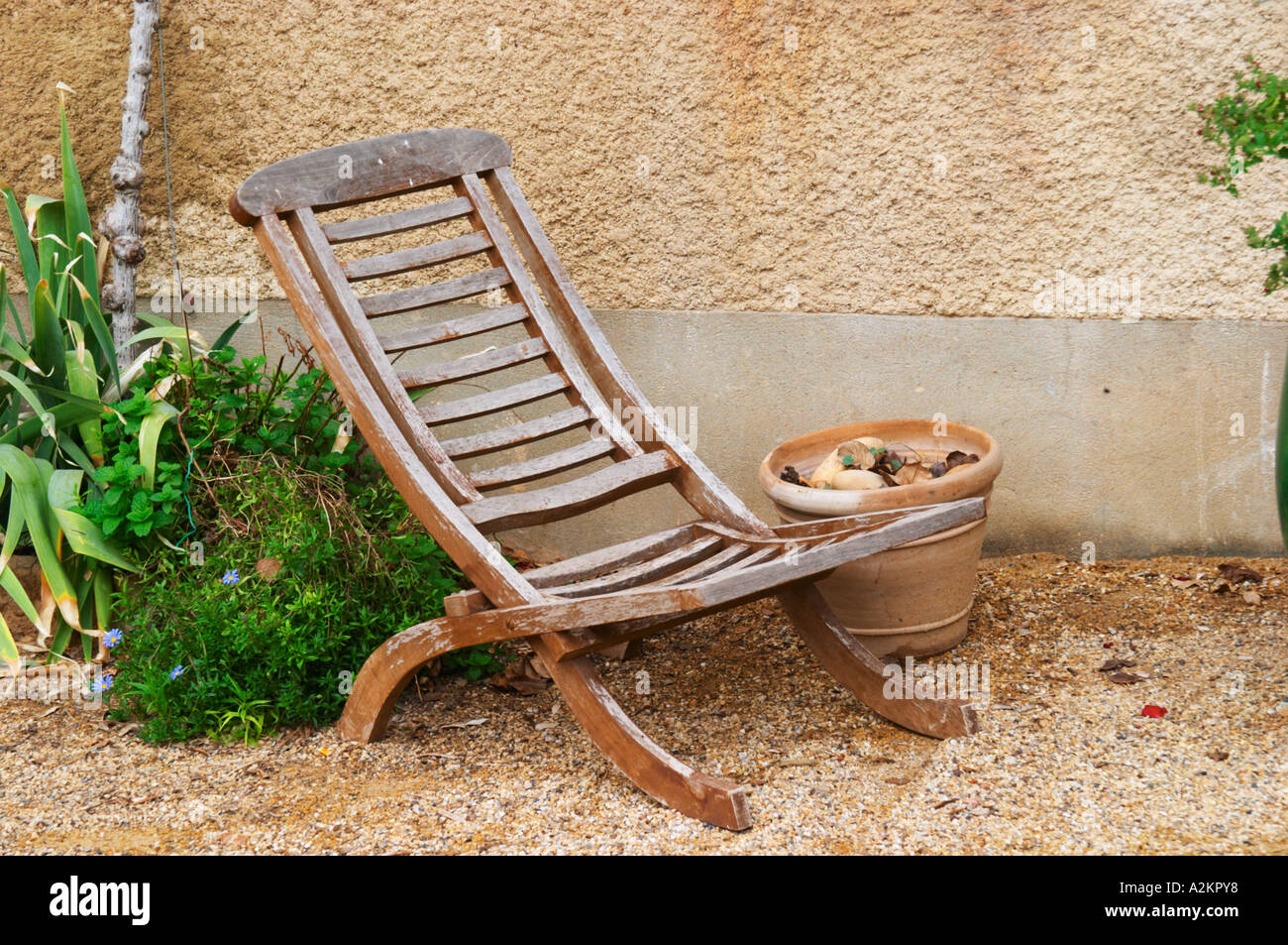 An old wooden garden lounge chair transat in a corner of the garden.  Chateau Mourgues du Gres Grès, Costieres de Nimes, Bouches Stock Photo -  Alamy