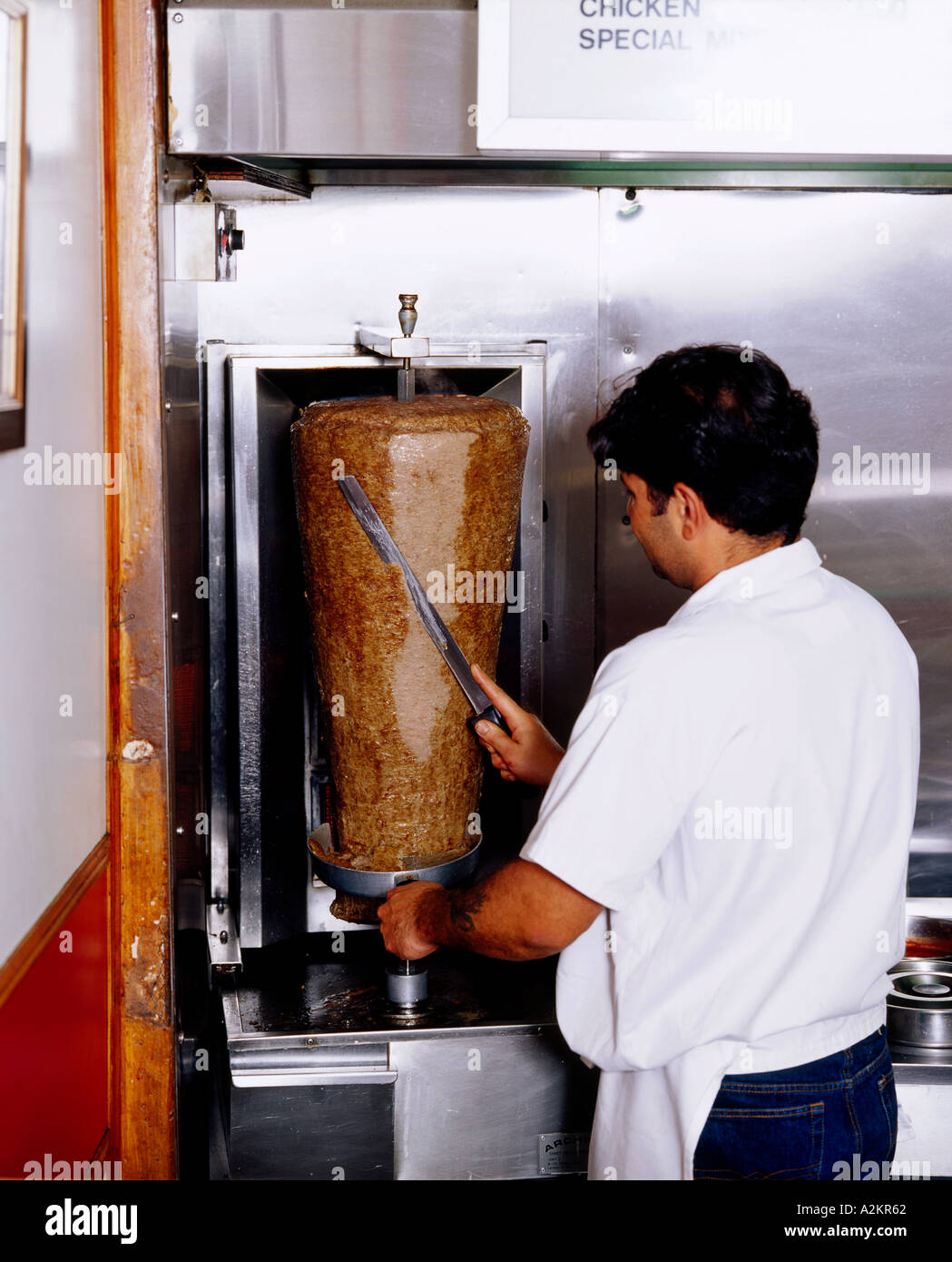 Man slicing donar doner meat in a kebab shop Stock Photo