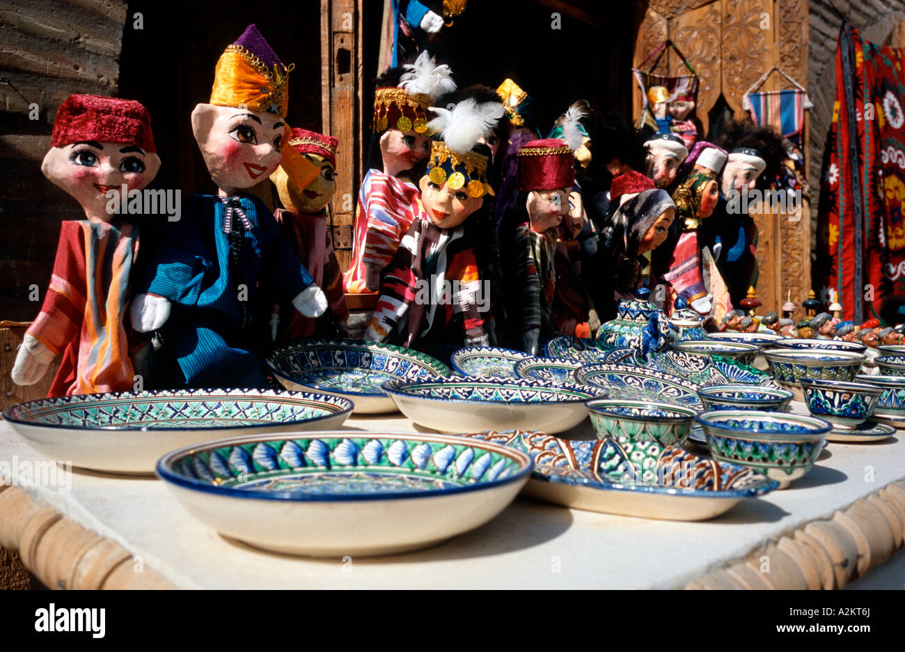 May 17, 2006 - Hand puppets and ceramcis, the traditional souvenirs, are on sale outside a mosque in the Uzbek town of Khiva. Stock Photo