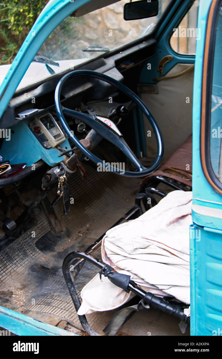 A blue old Citroen 2CV 2 CV converted into a transport van. Inside the driver seat and steering