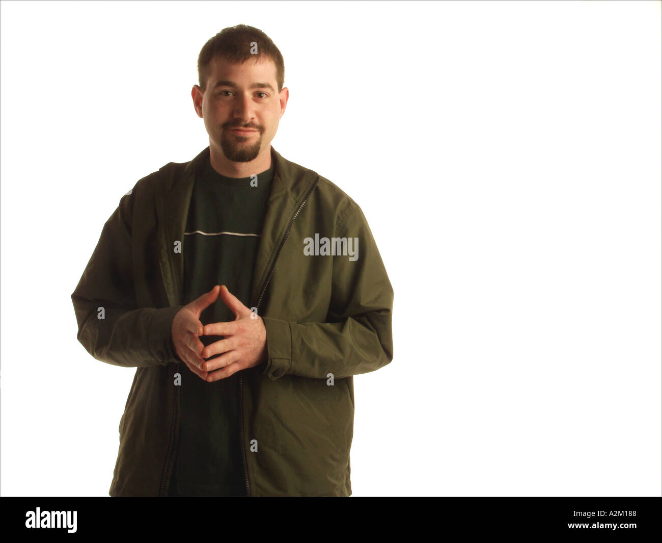 Studio shot of a casually dressed man standing with his fingertips
