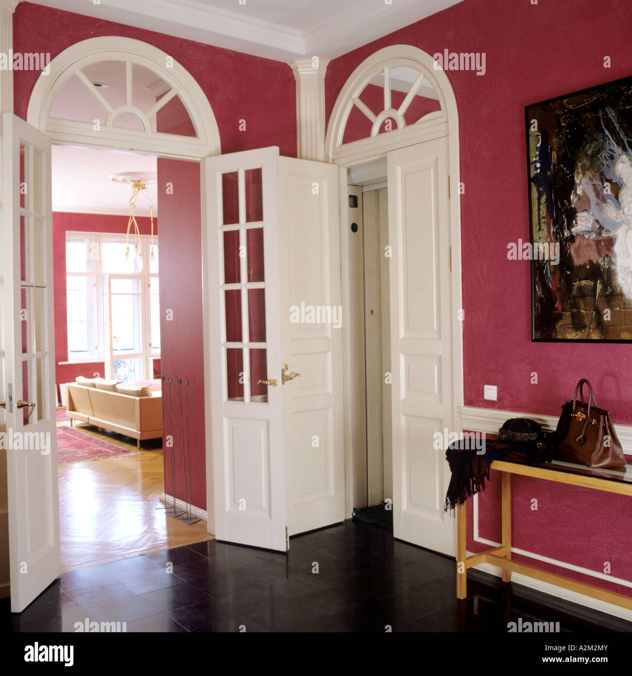 Hall with arched doorways in red painted apartment of St Petersburg art dealer Stock Photo