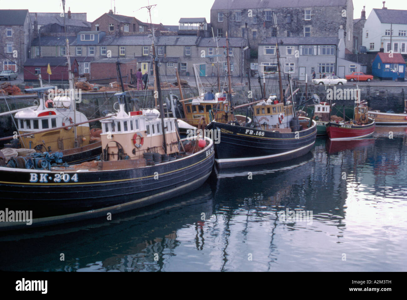 Fishing boats in Seahouses harbour in 1973, Northumberland, England, UK ...