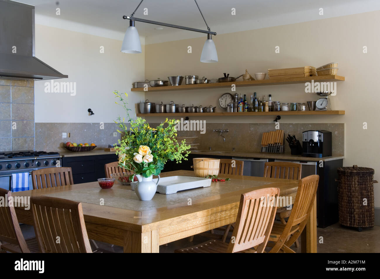 Large kitchen table with open shelving Stock Photo - Alamy