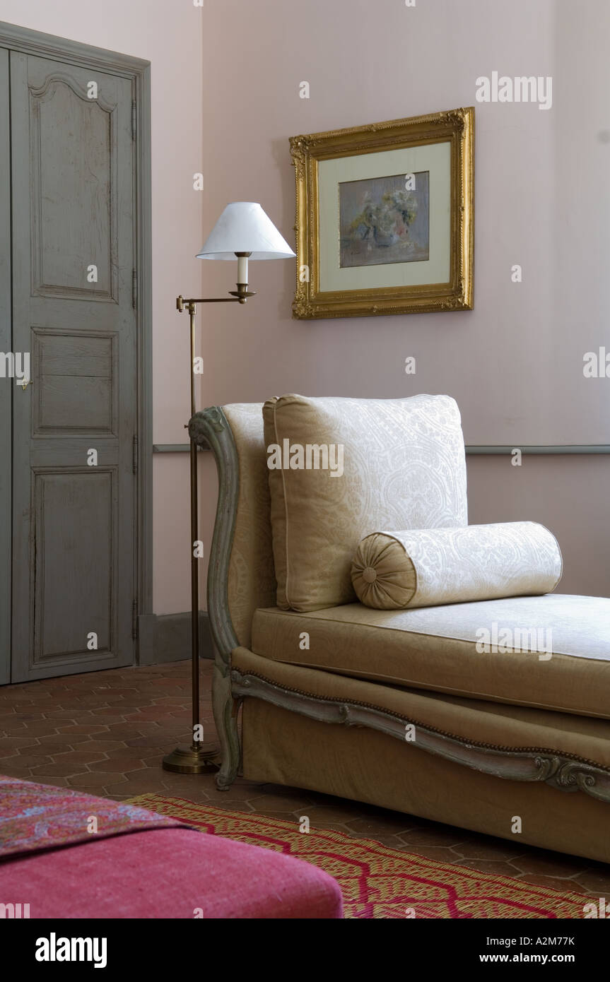 Elegantly upholstered daybed in living room with period lamp Stock ...