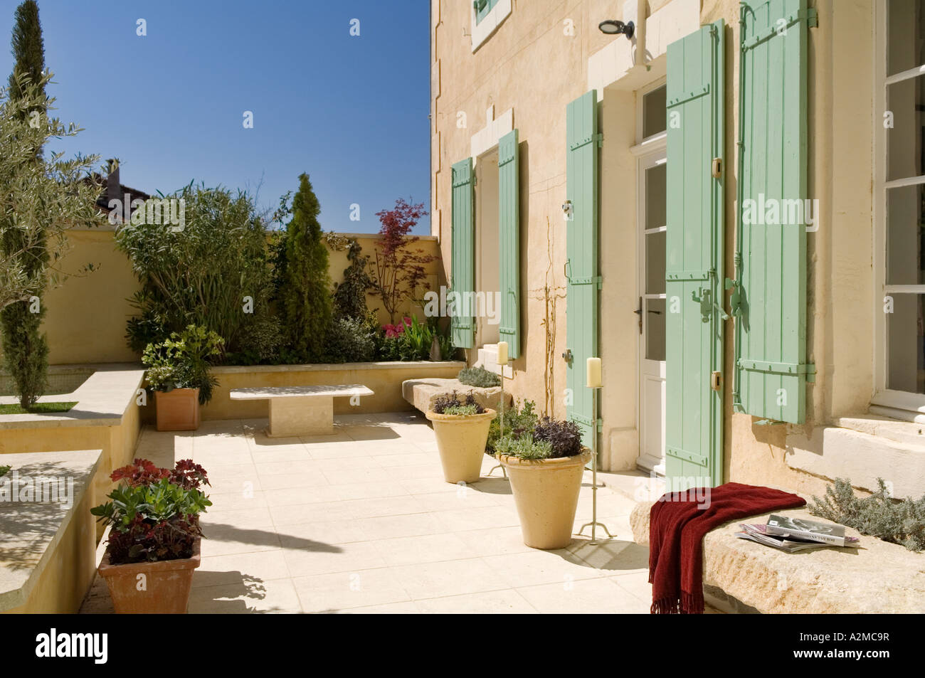Garden courtyard/ patio of Provençal villa with shutters, France Stock