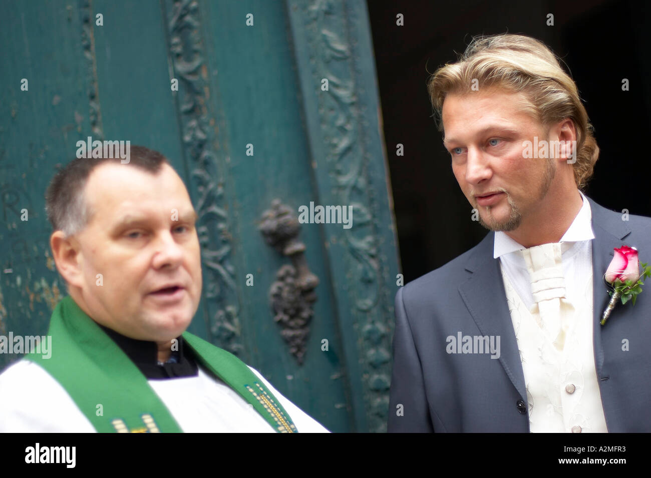 bridegroom with priest Stock Photo
