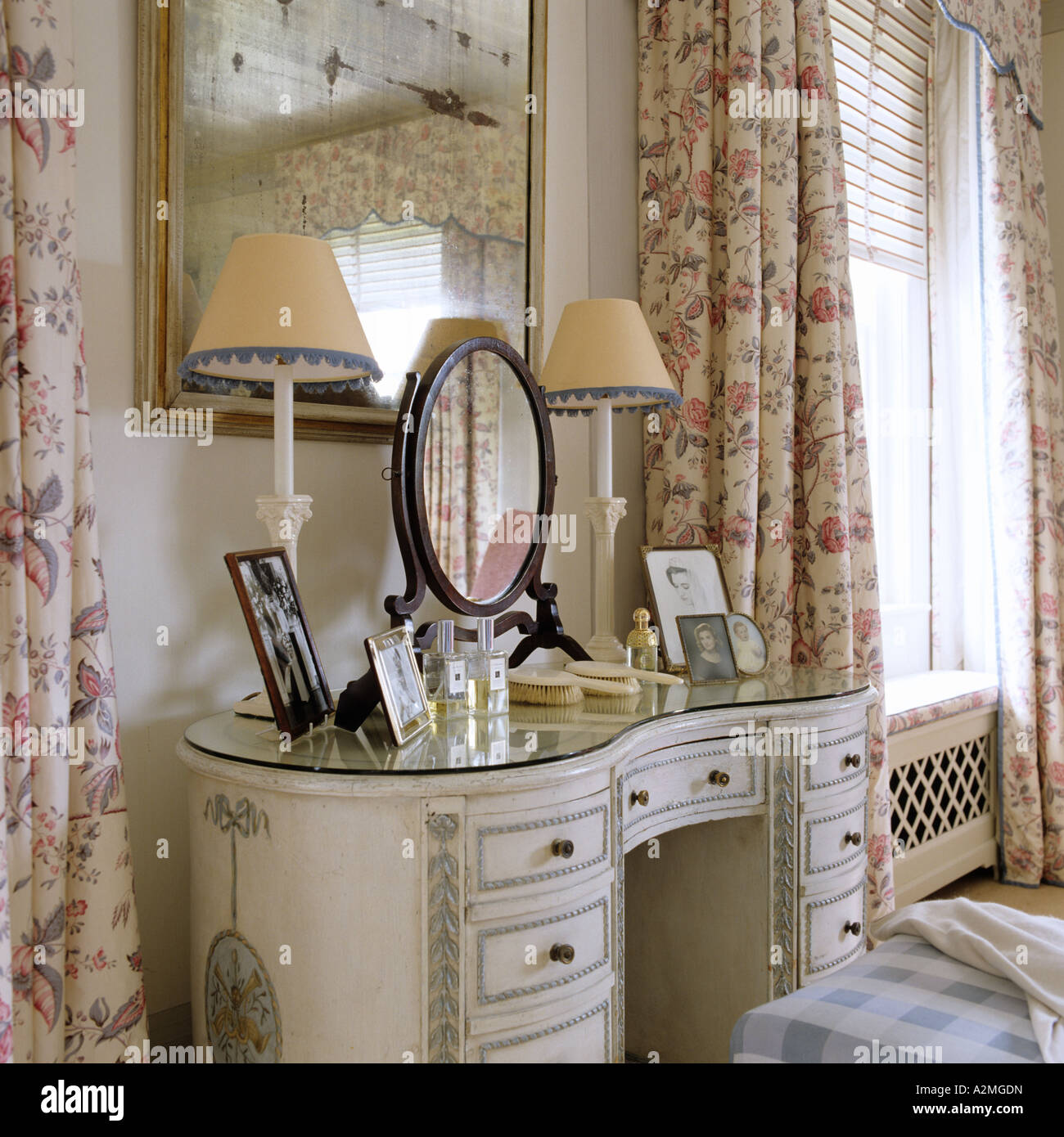 Dressing table and floral patterned curtains in bedroom of English country house Stock Photo