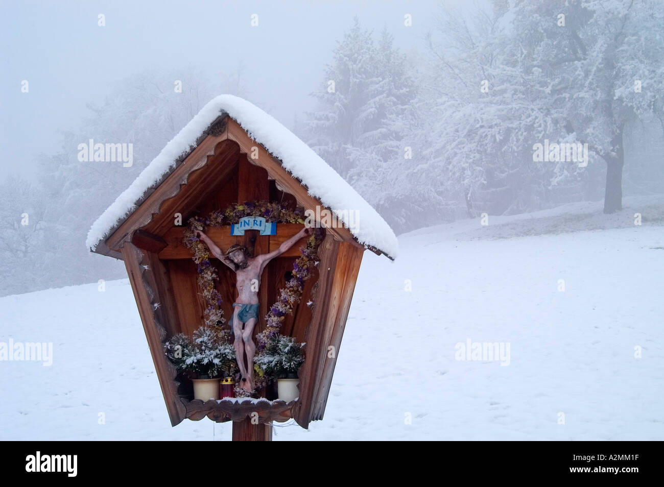 a wooden cross in the snow near the town of Köflach Styria Austria Stock Photo